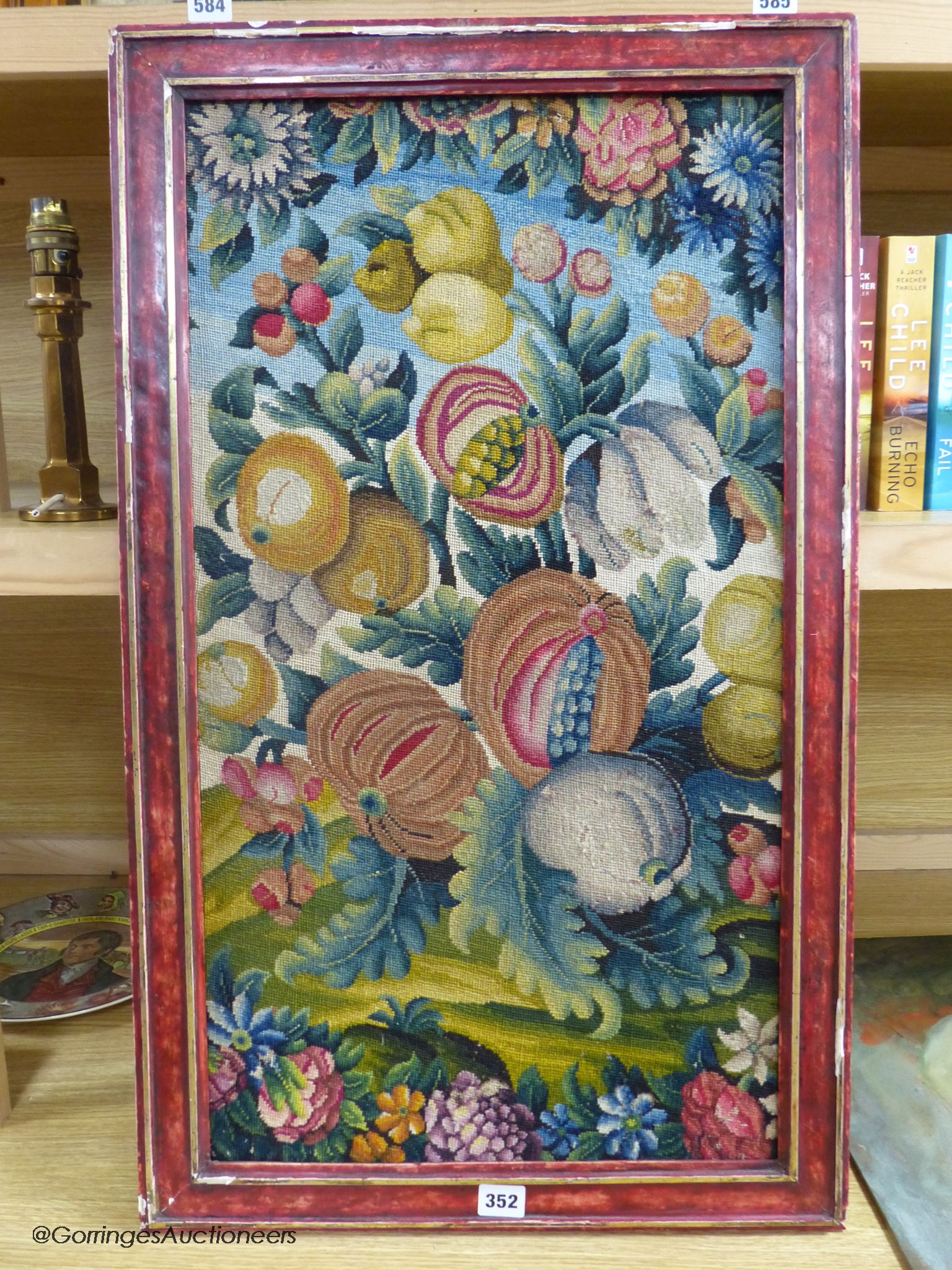 A framed 19th century woolwork panel depicting pomegranates, other fruit and flowers, 71 x 38cm